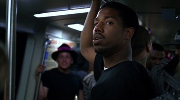 Movie still from “Fruitvale Station” (2013), directed by Ryan Coogler – A person on a train; Close Up shot, Over the shoulder angle