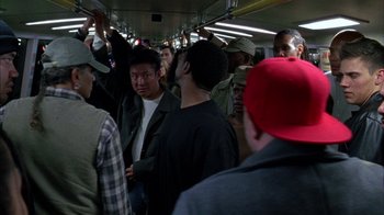 Movie still from “Fruitvale Station” (2013), directed by Ryan Coogler – A group of people standing on top of a subway train; Medium shot, High angle