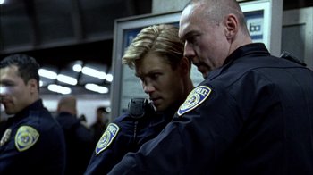 Movie still from “Fruitvale Station” (2013), directed by Ryan Coogler – Two police officers standing next to each other; Close Up shot, Low angle