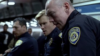 Movie still from “Fruitvale Station” (2013), directed by Ryan Coogler – A couple of police officers standing next to each other; Close Up shot, Low angle
