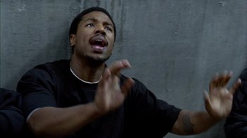Movie still from “Fruitvale Station” (2013), directed by Ryan Coogler – A man with a black shirt is looking up; Close Up shot, High angle