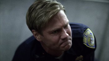Movie still from “Fruitvale Station” (2013), directed by Ryan Coogler – A man in a police uniform is looking down; Close Up shot, Low angle