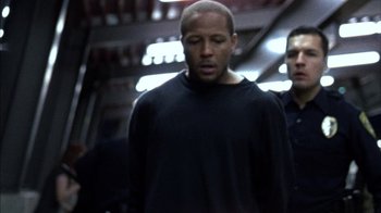 Movie still from “Fruitvale Station” (2013), directed by Ryan Coogler – A man in a black shirt and a man in a blue shirt; Medium shot, Over the shoulder angle