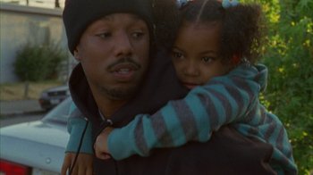 Movie still from “Fruitvale Station” (2013), directed by Ryan Coogler – A man holding a little girl in his arms; Close Up shot, High angle
