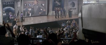 Movie still from “Galaxy Quest” (1999), directed by Dean Parisot – A crowd of people in front of a large screen; Wide shot, High angle