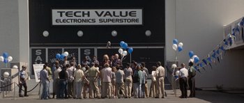 Movie still from “Galaxy Quest” (1999), directed by Dean Parisot – A group of people standing in front of an electronics store; Extreme Wide shot, High angle