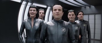 Movie still from “Galaxy Quest” (1999), directed by Dean Parisot – A group of men and women standing next to each other; Medium shot, Over the shoulder angle