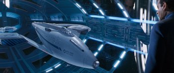Movie still from “Galaxy Quest” (1999), directed by Dean Parisot – An image of an airplane in the middle of a space station; Extreme Wide shot, Overhead angle