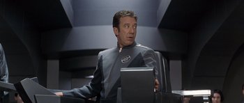Movie still from “Galaxy Quest” (1999), directed by Dean Parisot – A man sitting at a table with a computer in front of him; Close Up shot, Over the shoulder angle