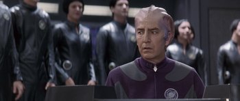 Movie still from “Galaxy Quest” (1999), directed by Dean Parisot – A group of men standing next to each other in a room; Close Up shot, Over the shoulder angle