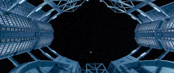 Movie still from “Galaxy Quest” (1999), directed by Dean Parisot – Looking up at the stars from underneath a building; Extreme Wide shot, Overhead angle