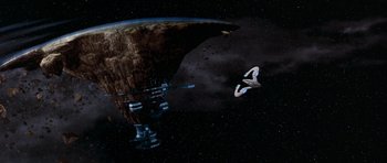 Movie still from “Galaxy Quest” (1999), directed by Dean Parisot – An image of an alien space ship in the dark sky; Extreme Wide shot, High angle