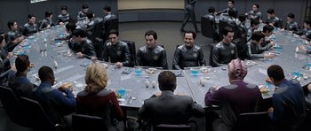 Movie still from “Galaxy Quest” (1999), directed by Dean Parisot – A group of people sitting around a table; Medium shot, High angle