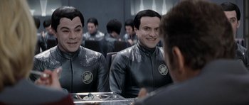 Movie still from “Galaxy Quest” (1999), directed by Dean Parisot – Two men in space suits sitting in front of a mirror; Close Up shot, Over the shoulder angle