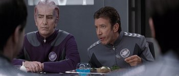 Movie still from “Galaxy Quest” (1999), directed by Dean Parisot – Two people sitting at a table with a plate of food in front of them; Medium shot, Over the shoulder angle