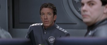 Movie still from “Galaxy Quest” (1999), directed by Dean Parisot – A person wearing a uniform; Close Up shot, Over the shoulder angle