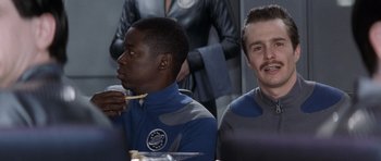 Movie still from “Galaxy Quest” (1999), directed by Dean Parisot – Two people sitting at a table eating food; Medium shot, Over the shoulder angle