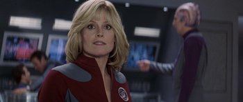 Movie still from “Galaxy Quest” (1999), directed by Dean Parisot – A person wearing a red and white jacket; Close Up shot, Over the shoulder angle