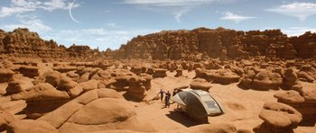 Movie still from “Galaxy Quest” (1999), directed by Dean Parisot – Two men standing next to a boat in the desert; Extreme Wide shot, High angle