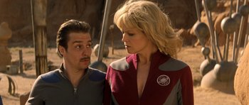 Movie still from “Galaxy Quest” (1999), directed by Dean Parisot – A man and a woman standing next to each other; Medium shot, Low angle