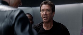 Movie still from “Galaxy Quest” (1999), directed by Dean Parisot – A person in a black shirt; Close Up shot, Over the shoulder angle