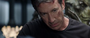 Movie still from “Galaxy Quest” (1999), directed by Dean Parisot – A person with a scar on his face; Close Up shot, Over the shoulder angle