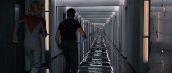 Movie still from “Galaxy Quest” (1999), directed by Dean Parisot – A man walking down a long hallway in a building; Wide shot, High angle