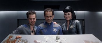 Movie still from “Galaxy Quest” (1999), directed by Dean Parisot – A man and two women standing next to each other; Medium shot, Over the shoulder angle