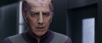 Movie still from “Galaxy Quest” (1999), directed by Dean Parisot – A man with a bald head and a purple shirt; Close Up shot, Over the shoulder angle