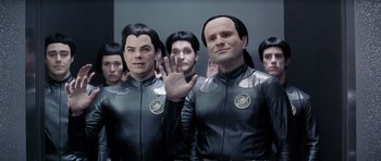 Movie still from “Galaxy Quest” (1999), directed by Dean Parisot – A group of men dressed in black and grey costumes; Medium shot, High angle