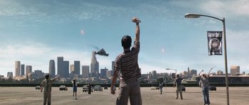 Movie still from “Galaxy Quest” (1999), directed by Dean Parisot – A man is flying a kite in a parking lot; Extreme Wide shot, Low angle
