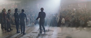 Movie still from “Galaxy Quest” (1999), directed by Dean Parisot – A crowd of people watching a man on a stage; Wide shot, Low angle