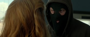 Movie still from “Hell or High Water” (2016), directed by David Mackenzie – A person wearing a hooded sweatshirt and a mask; Close Up shot, Over the shoulder angle