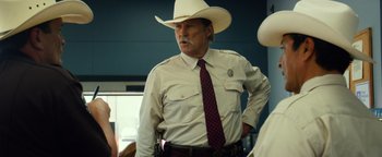 Movie still from “Hell or High Water” (2016), directed by David Mackenzie – A man in a white cowboy hat and tie; Medium shot, Over the shoulder angle