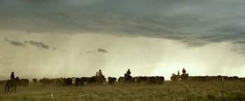Movie still from “Hell or High Water” (2016), directed by David Mackenzie – A herd of cattle being herded by two men on horseback; Extreme Wide shot, Low angle