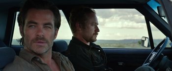 Movie still from “Hell or High Water” (2016), directed by David Mackenzie – Two men sitting in the back seat of a car; Close Up shot, Over the shoulder angle