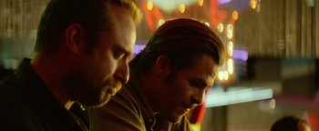 Movie still from “Hell or High Water” (2016), directed by David Mackenzie – A man with long hair is looking at another man with long hair; Close Up shot, Low angle