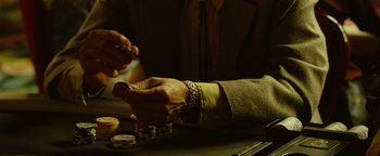 Movie still from “Hell or High Water” (2016), directed by David Mackenzie – A person is holding a pair of hands while playing a game of poker; Extreme Close Up shot, High angle