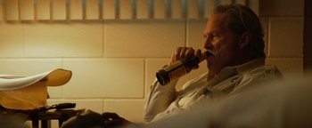 Movie still from “Hell or High Water” (2016), directed by David Mackenzie – An older man is drinking a beer in a room; Close Up shot, Low angle