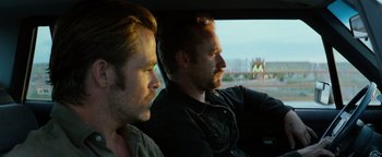 Movie still from “Hell or High Water” (2016), directed by David Mackenzie – A couple of men sitting in the back of a car; Close Up shot, Over the shoulder angle