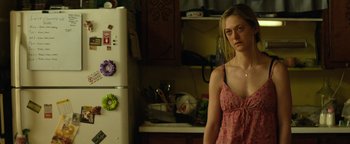 Movie still from “Hell or High Water” (2016), directed by David Mackenzie – A woman standing in a kitchen next to a refrigerator; Medium shot, Over the shoulder angle