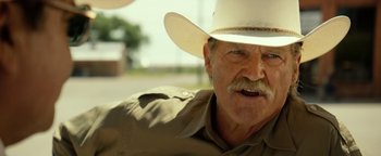 Movie still from “Hell or High Water” (2016), directed by David Mackenzie – An older man wearing a white cowboy hat; Close Up shot, Over the shoulder angle