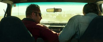 Movie still from “Hell or High Water” (2016), directed by David Mackenzie – A man sitting in the driver's seat of a car; Medium shot, Over the shoulder angle