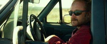 Movie still from “Hell or High Water” (2016), directed by David Mackenzie – A man sitting in the driver's seat of a car; Close Up shot, Low angle