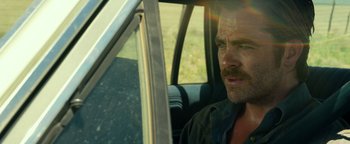 Movie still from “Hell or High Water” (2016), directed by David Mackenzie – A person sitting in a car; Close Up shot, Over the shoulder angle