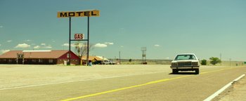 Movie still from “Hell or High Water” (2016), directed by David Mackenzie – A motel and gas station on the side of the road; Extreme Wide shot, Low angle