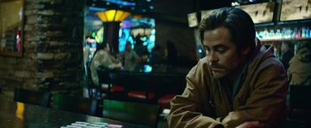 Movie still from “Hell or High Water” (2016), directed by David Mackenzie – A man sitting at a table in front of other people in a restaurant; Medium shot, Over the shoulder angle