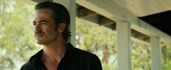 Movie still from “Hell or High Water” (2016), directed by David Mackenzie – A person wearing a black shirt; Close Up shot, Over the shoulder angle