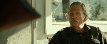 Movie still from “Hell or High Water” (2016), directed by David Mackenzie – An older man sitting in front of a window; Close Up shot, Low angle
