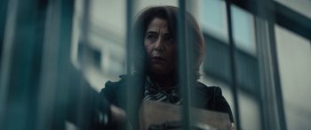 Movie still from “Hellraiser” (2022), directed by David Bruckner – A woman standing behind bars looking out of a window; Close Up shot, Low angle